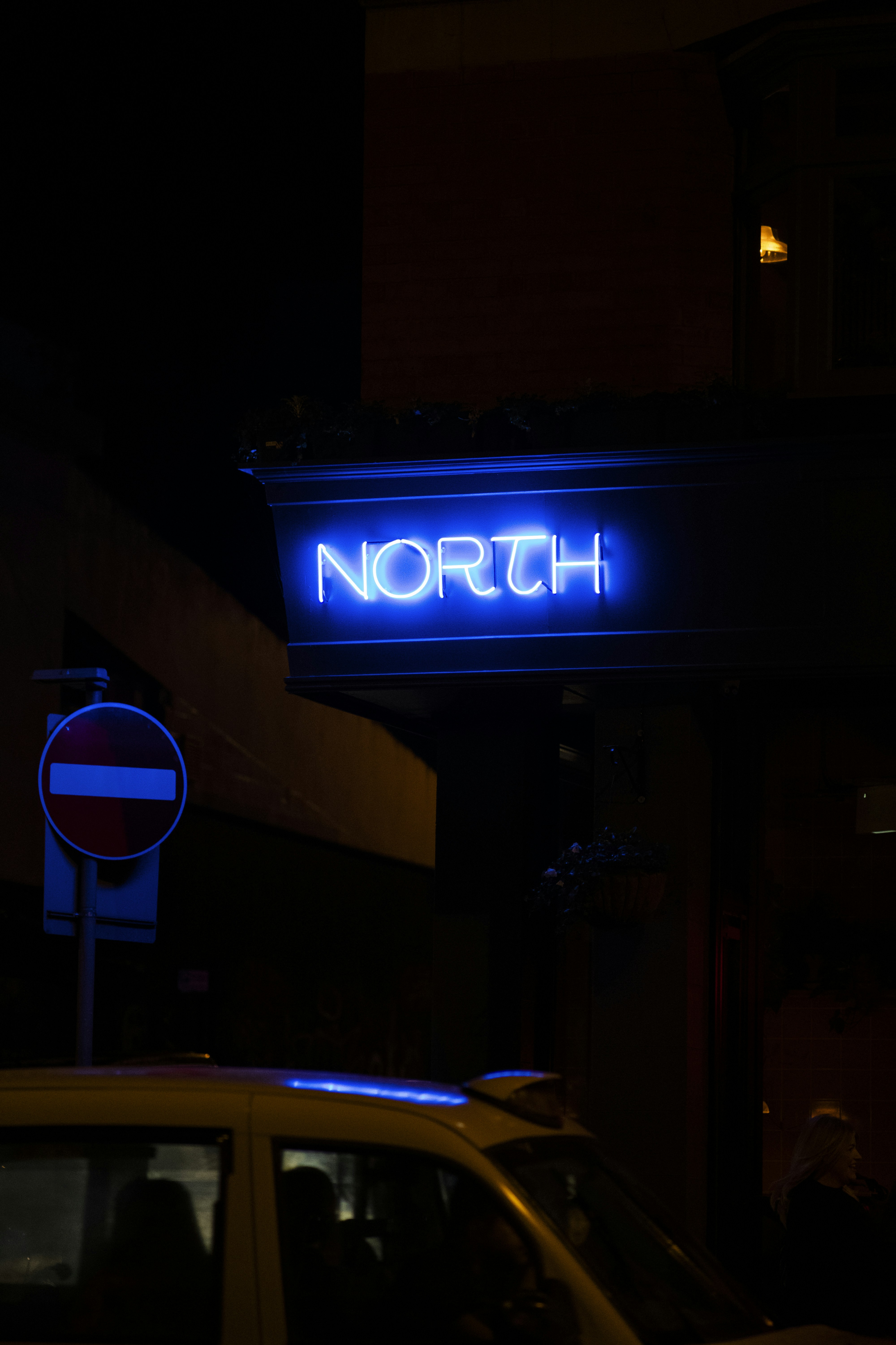 a car parked in front of a building at night