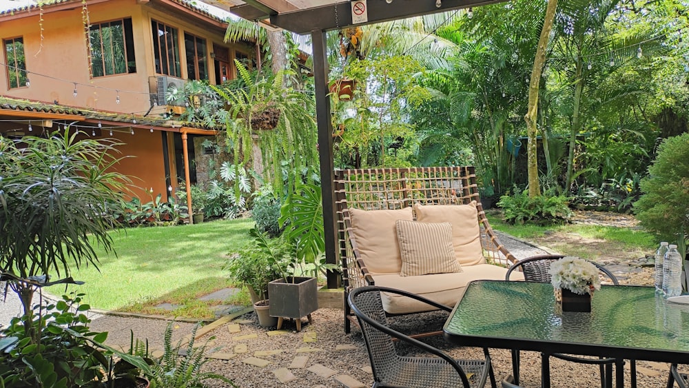 a patio with a table, chairs and a couch