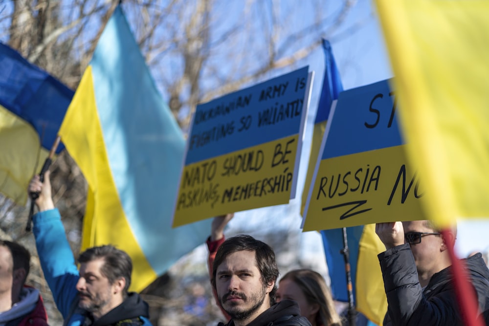 a group of people holding up signs in the air