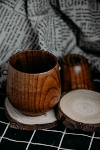 a wooden cup sitting on top of a wooden coaster