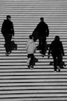 a group of people walking up a flight of stairs