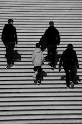 a group of people walking up a flight of stairs