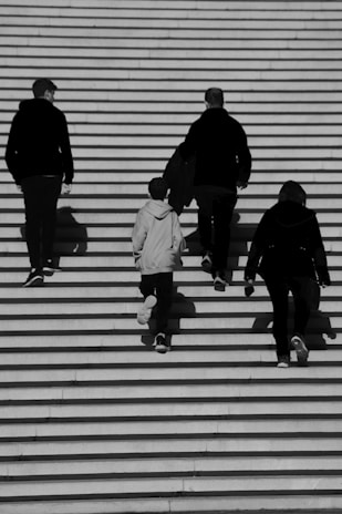 a group of people walking up a flight of stairs