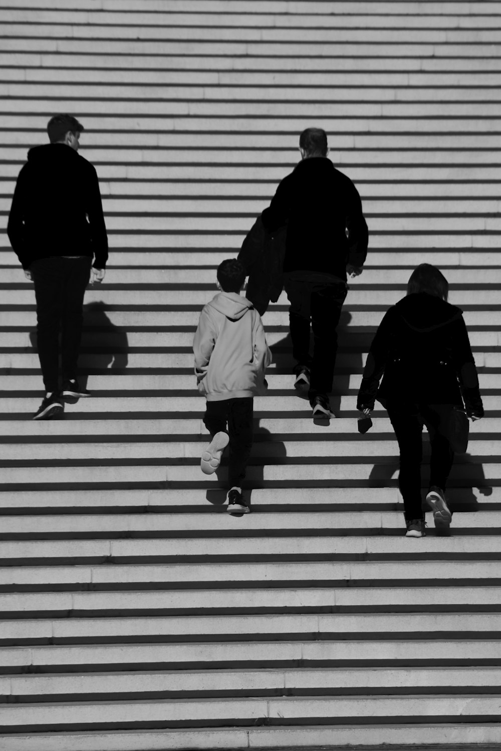 a group of people walking up a flight of stairs