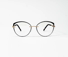 a pair of glasses sitting on top of a white surface