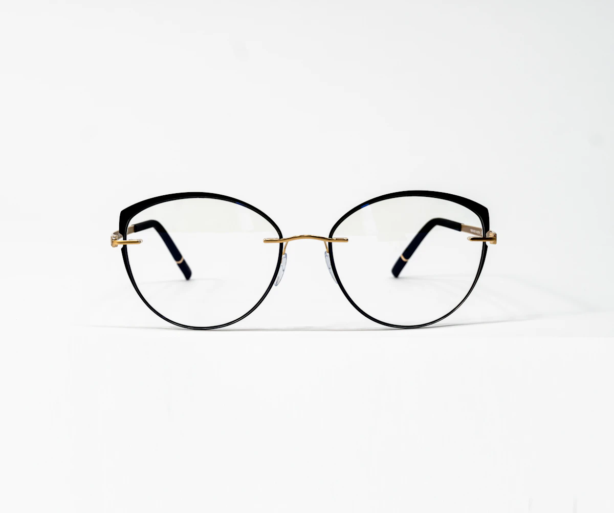 Pair of eyeglasses on a white surface