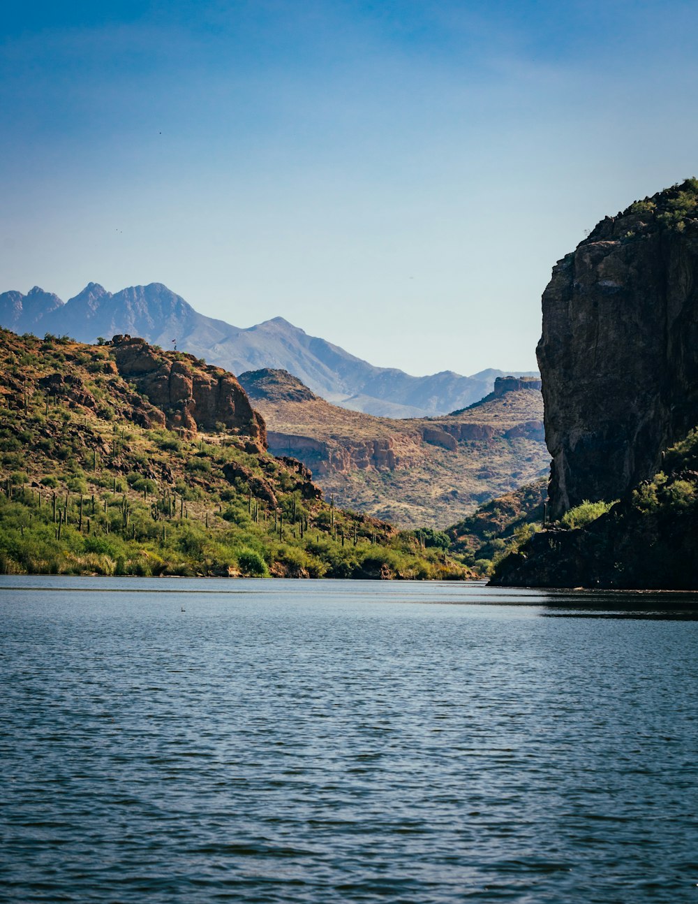 a body of water with mountains in the background