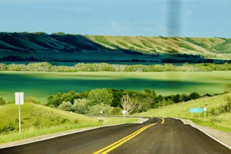 A scenic view of a driving route with clear road signs.
