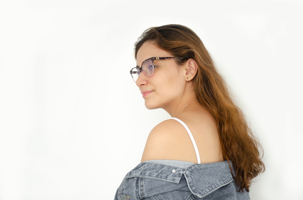 a woman with glasses is posing for a picture