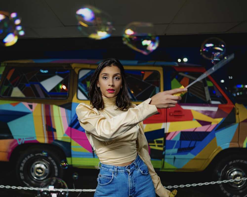 a woman is holding a wand in front of a van