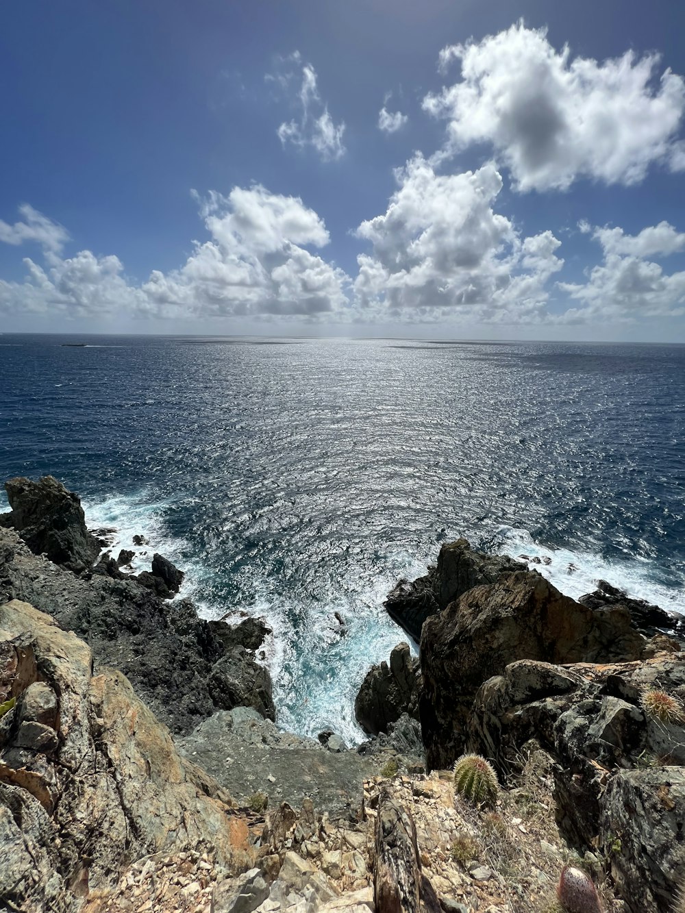 a view of the ocean from a rocky cliff