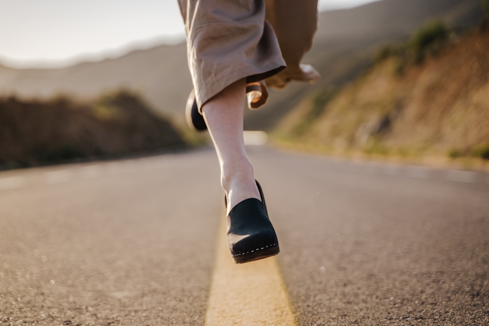 a person walking down the middle of a road