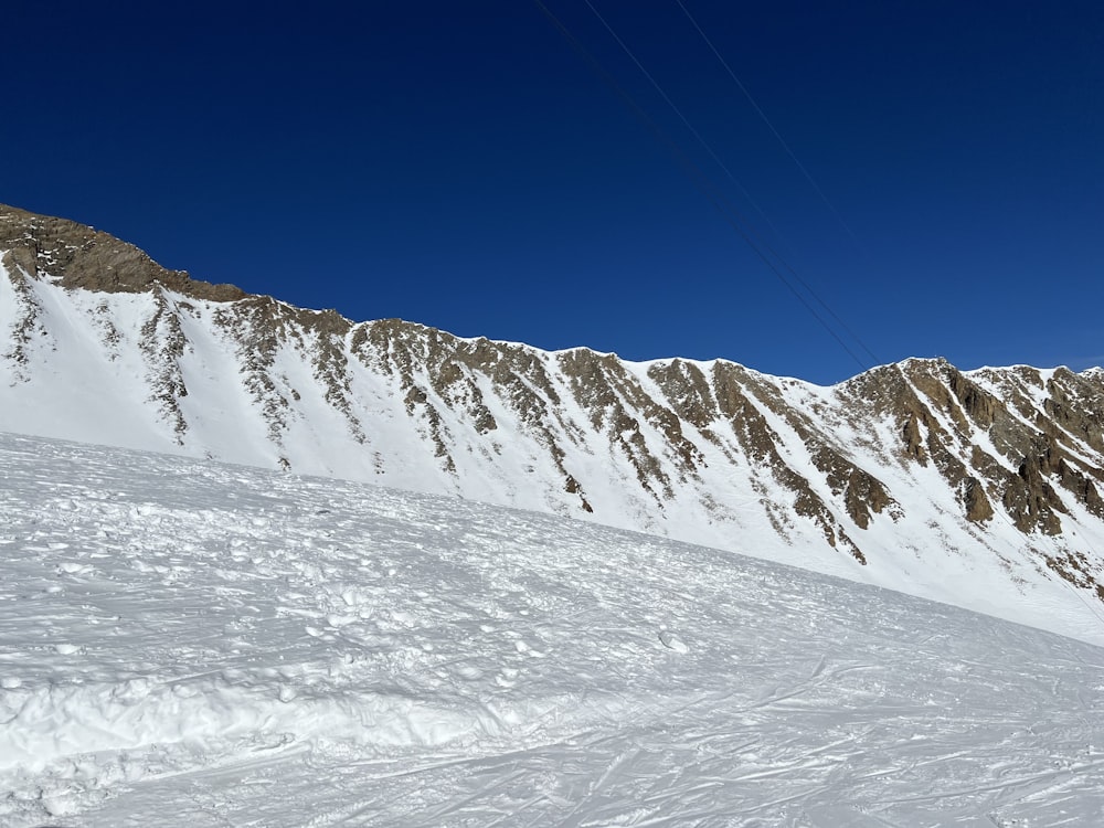 a man riding skis down a snow covered slope