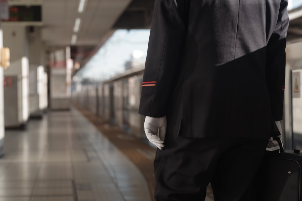 a man in a suit and tie holding a suitcase