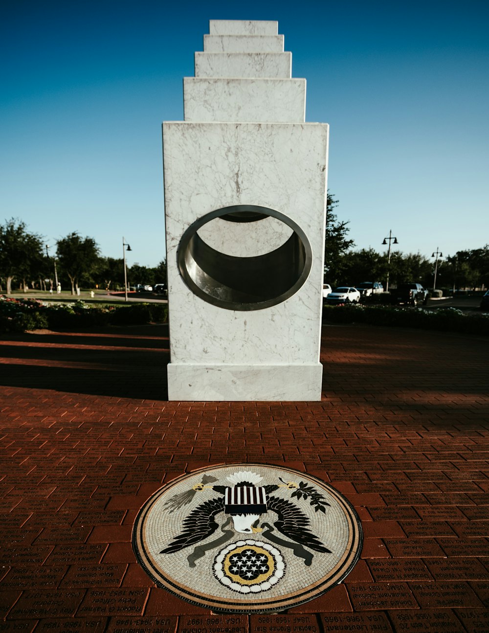a monument with a flag and a coat of arms on it