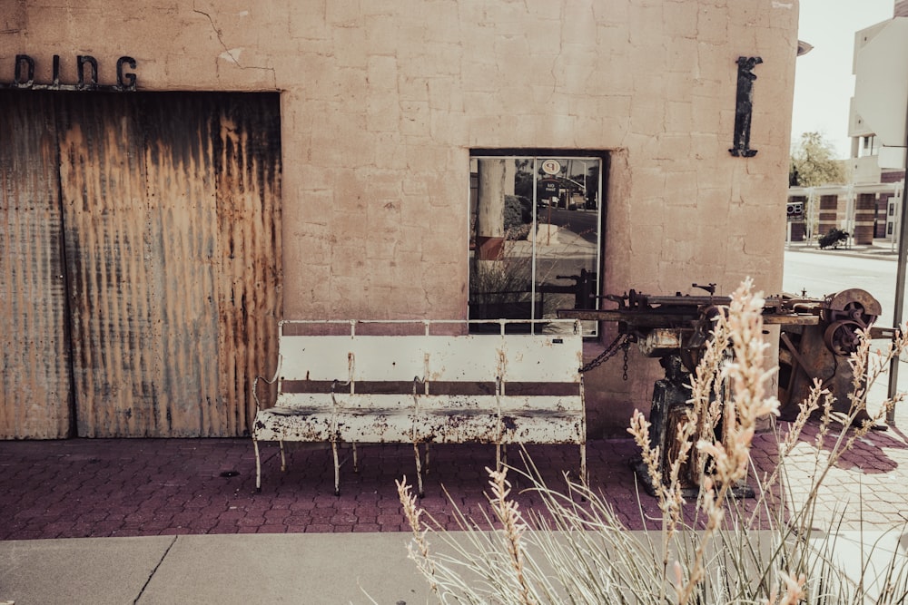 a bench sitting in front of a building