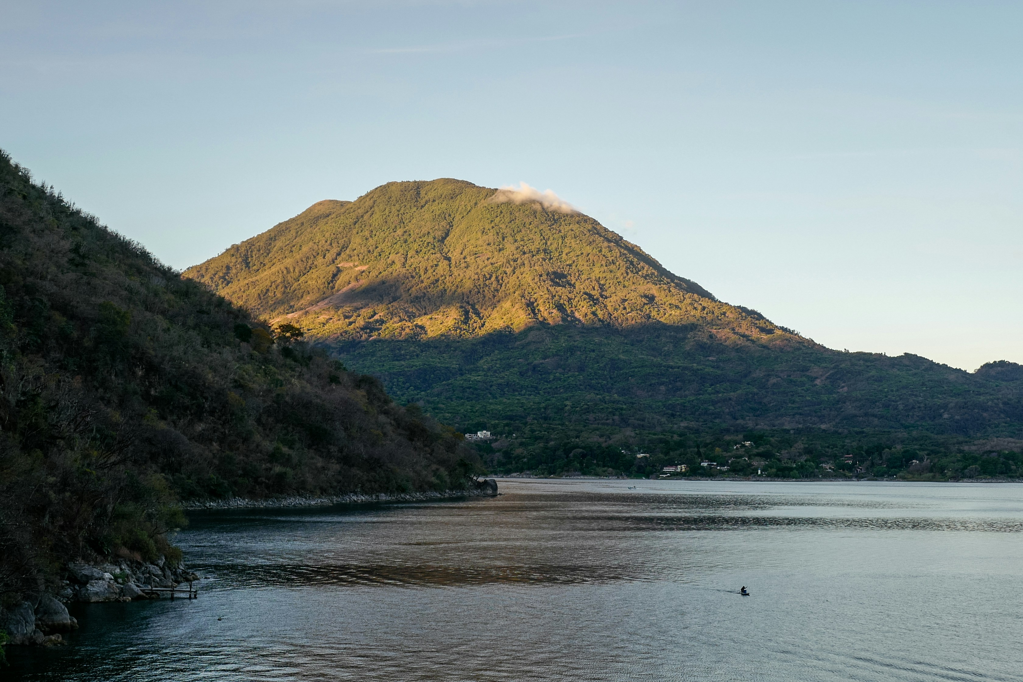 a body of water with a mountain in the background