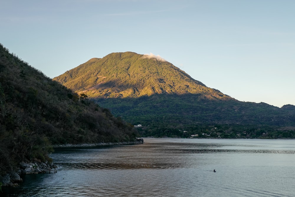 a body of water with a mountain in the background