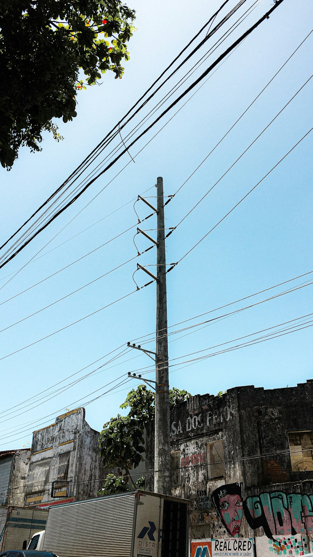 a tall pole with power lines above it