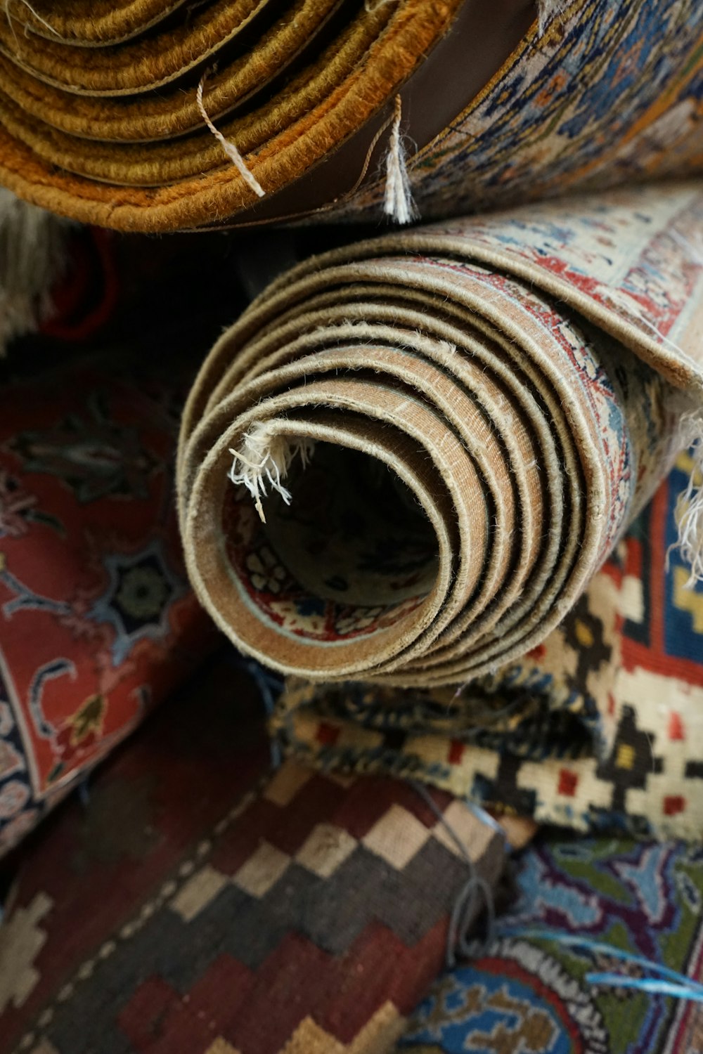 a pile of carpets and rugs on the floor