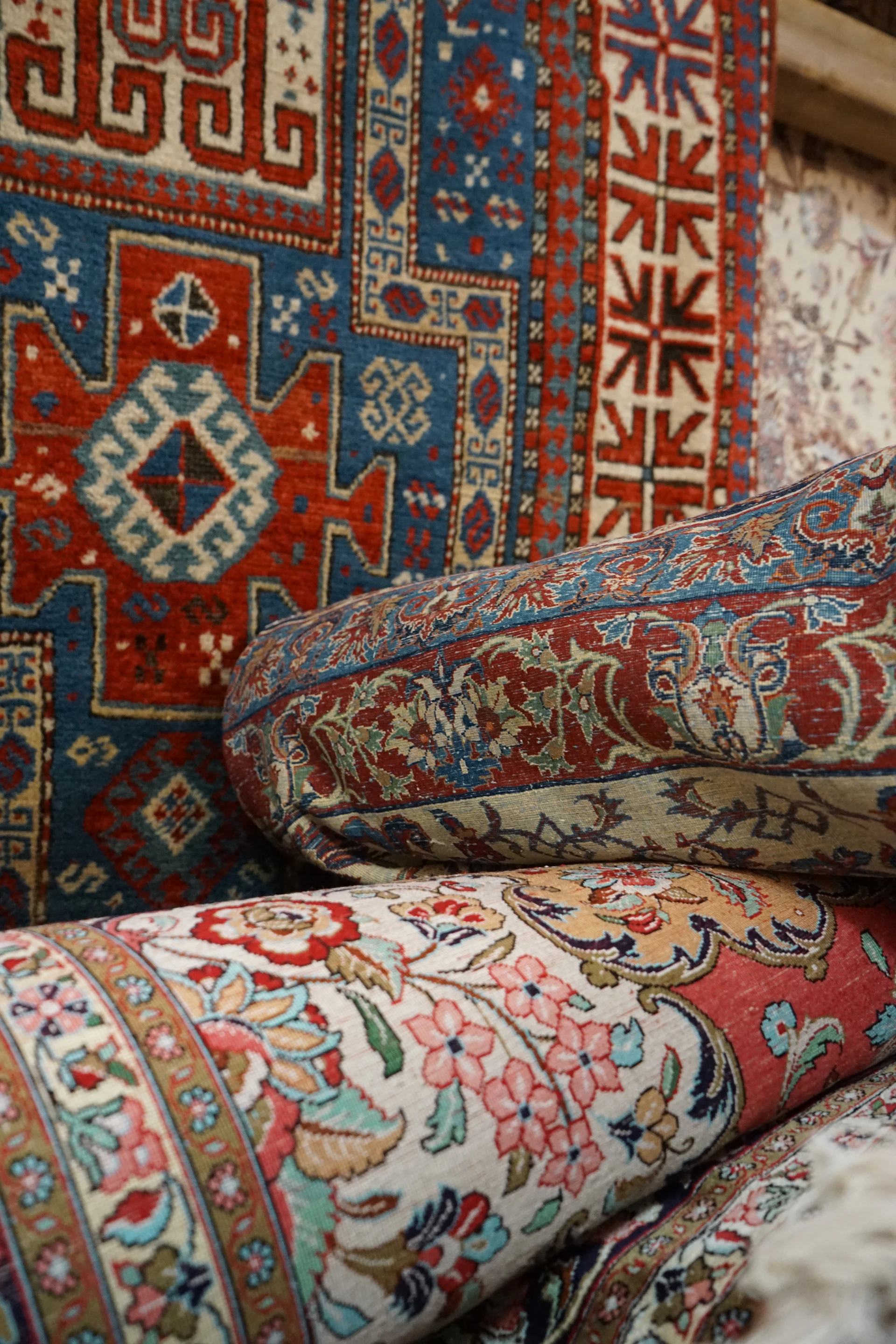 a pile of colorful rugs sitting on top of each other