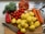 Man happily unpacking groceries with fresh vegetables on the kitchen counter