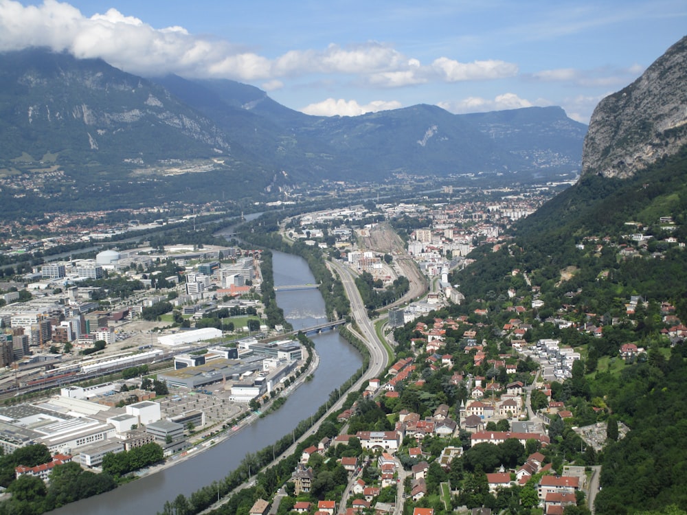 a river running through a city surrounded by mountains