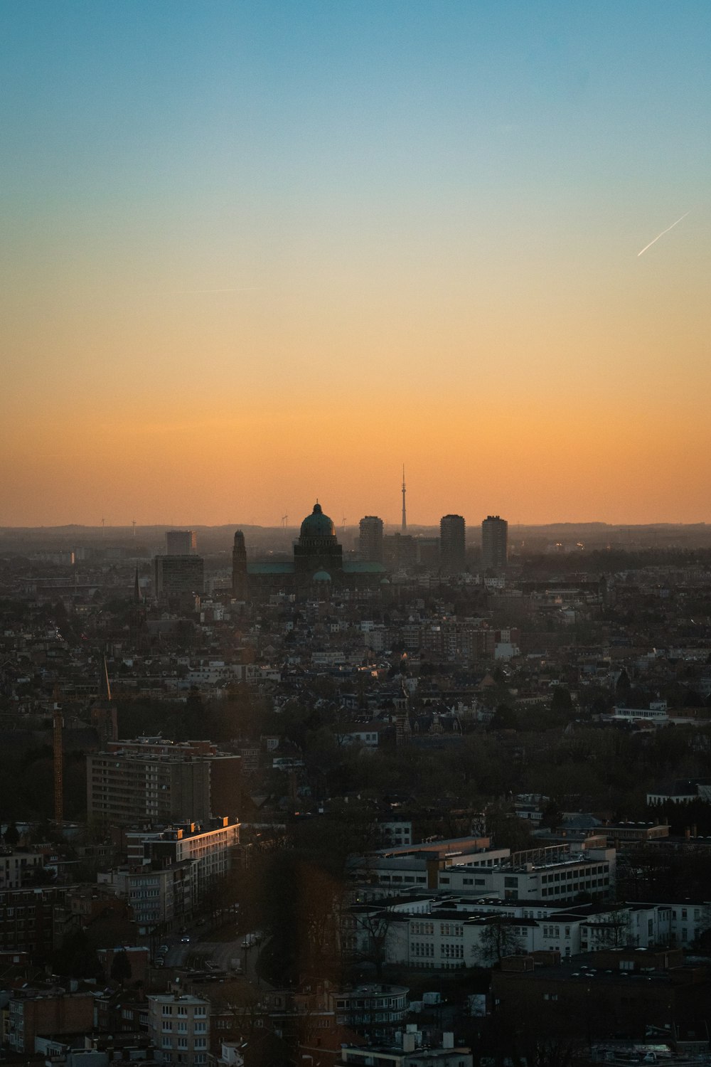 a view of a city at sunset from the top of a building