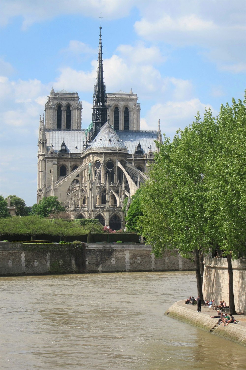 a large cathedral towering over a city next to a river