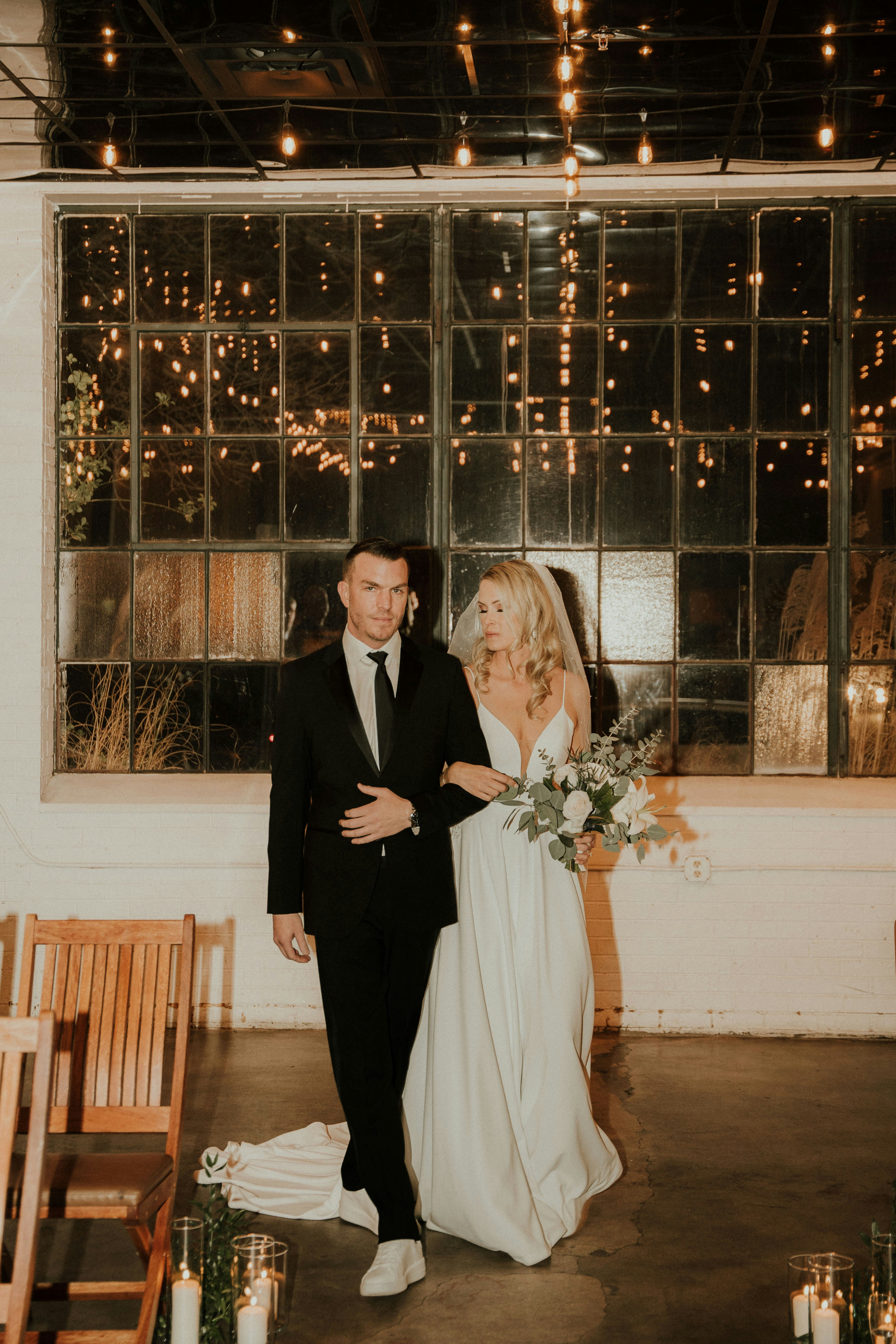 a bride and groom walking down the aisle