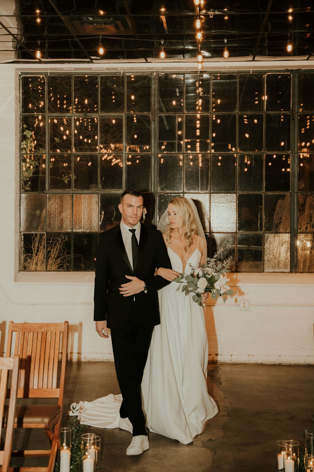 a bride and groom walking down the aisle