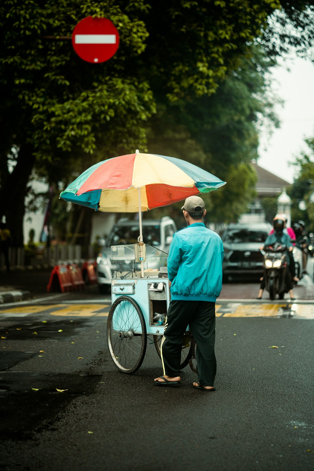 a man standing next to a bike with an umbrella