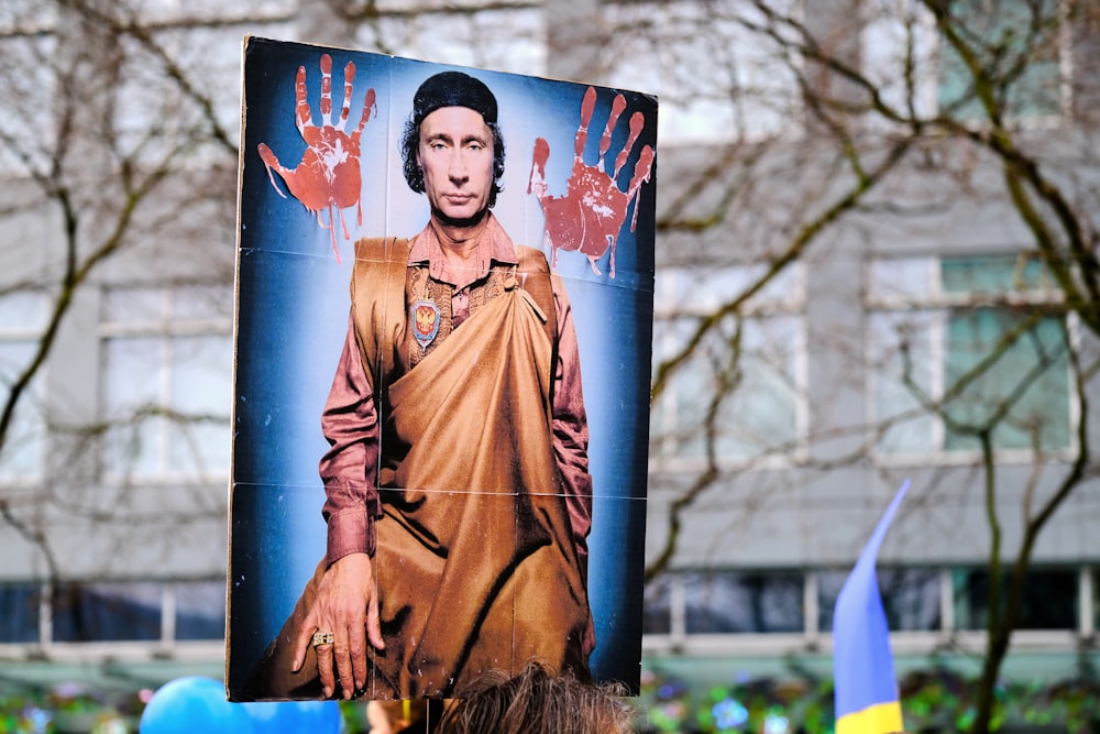 a large poster of a man with hands on it