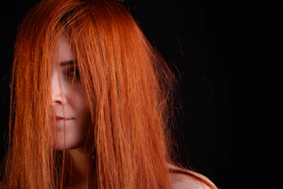 a close up of a woman with red hair