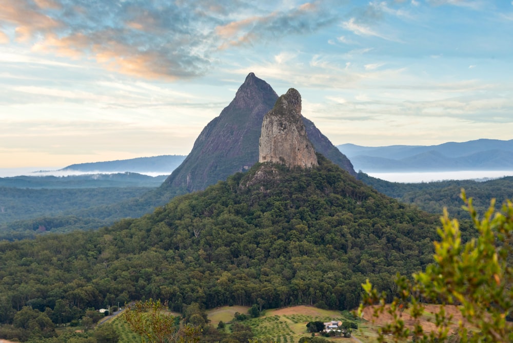 a view of a mountain with a few trees in the foreground