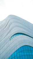 An exterior shot of a modern structure with unique curves.