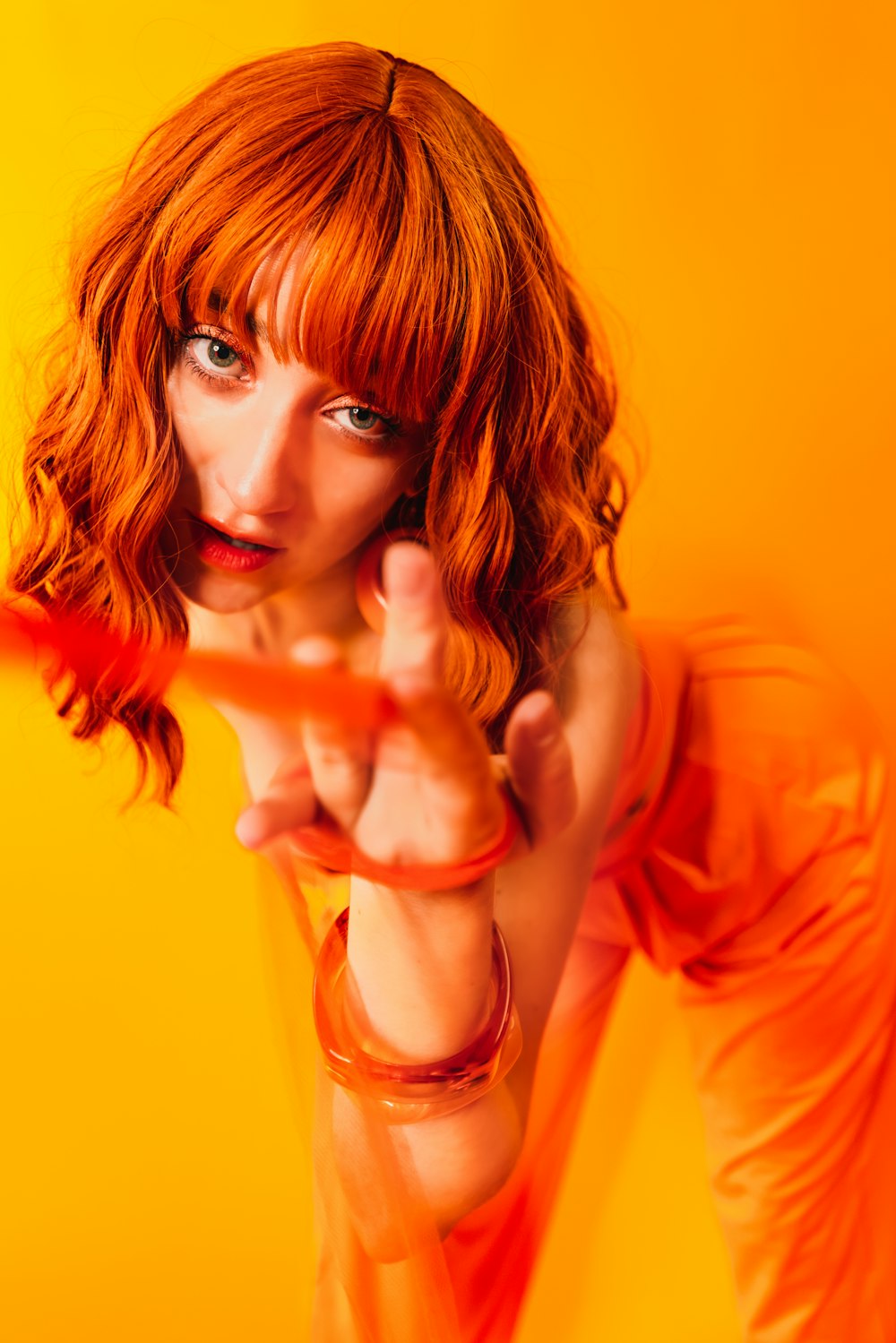 a woman pointing a gun at the camera