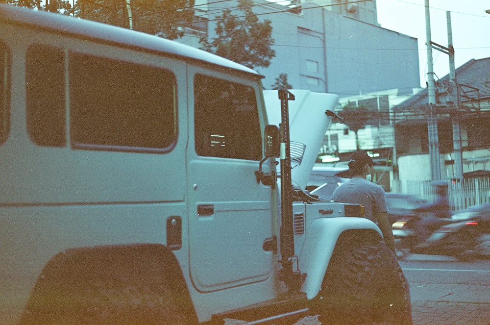 a white truck parked on the side of a road