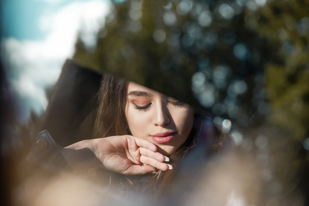 a woman with her hand on her face