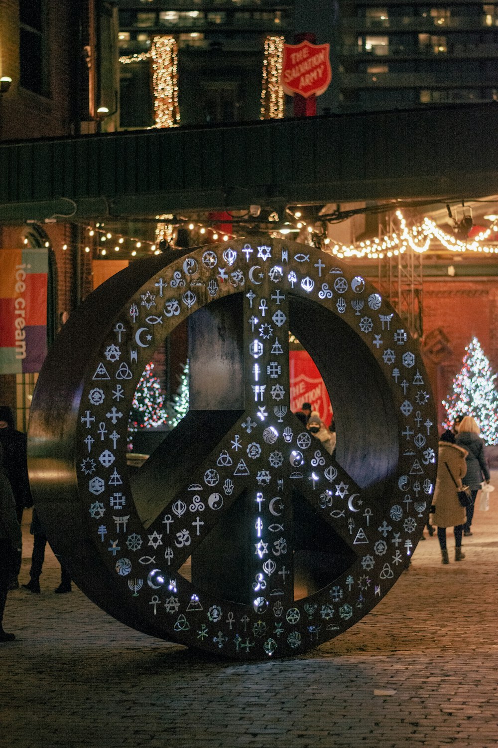 a peace sign on a city street at night