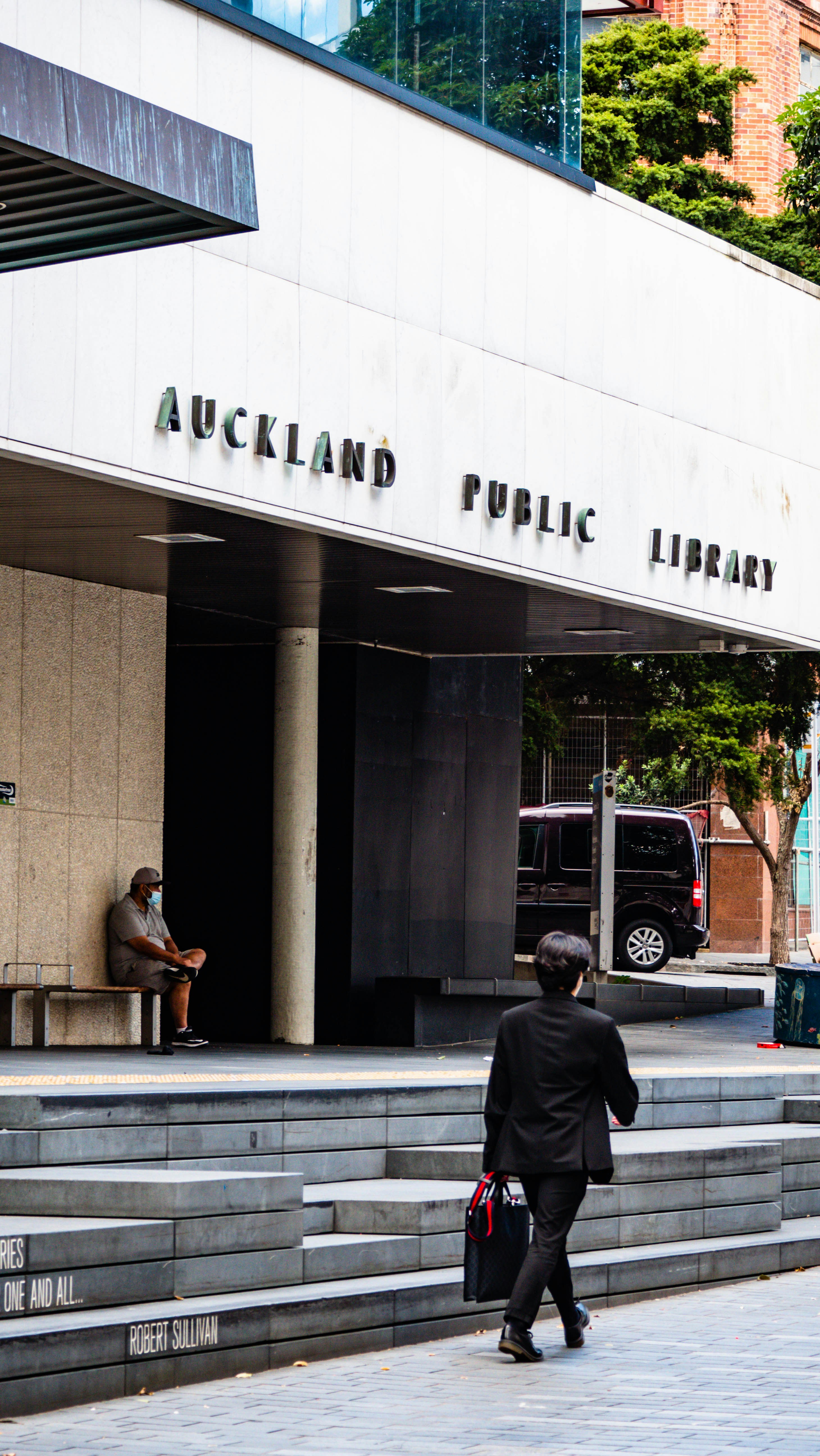 a man in a suit walking down the street