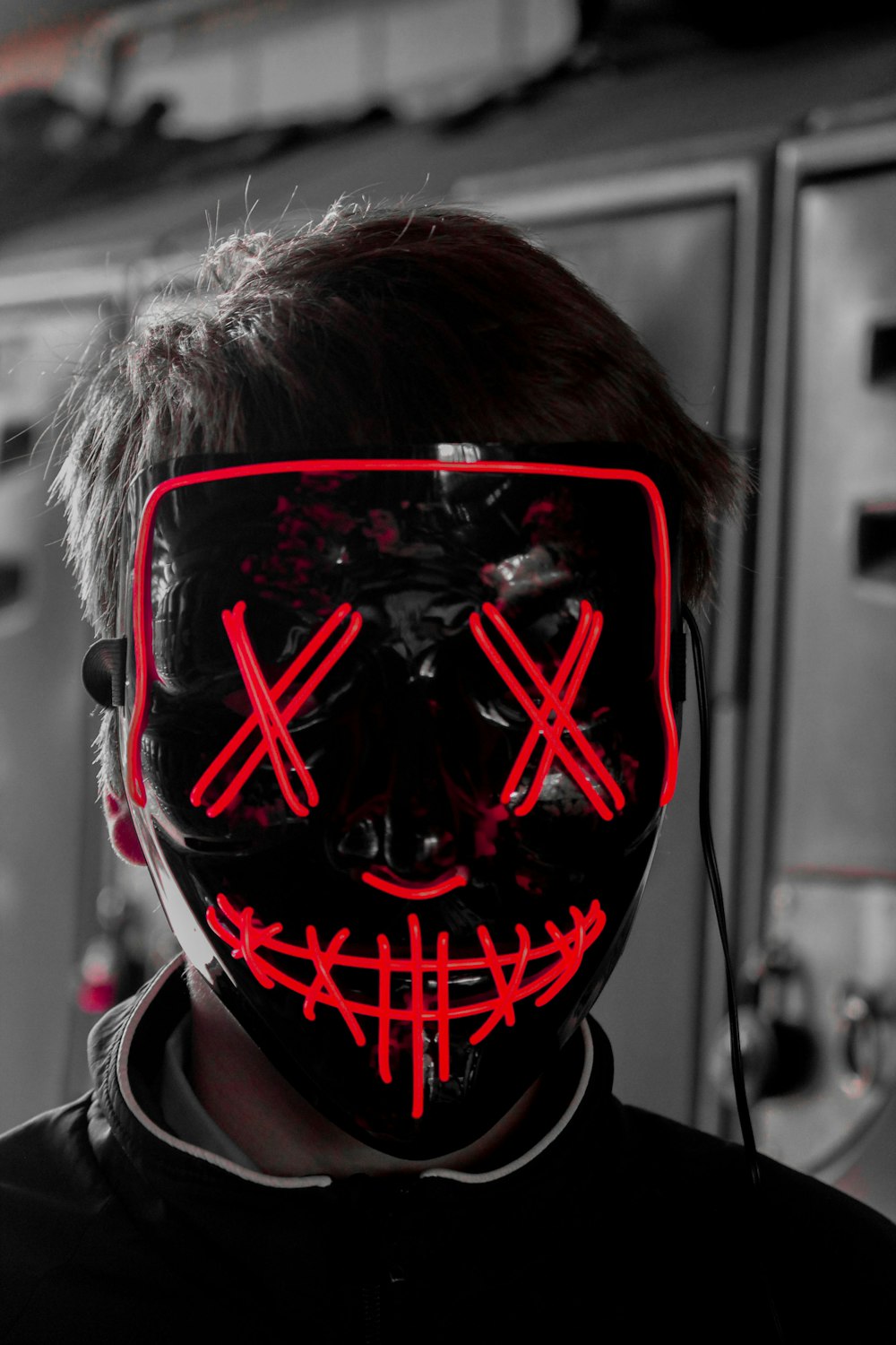 a man wearing a mask with red lights on his face