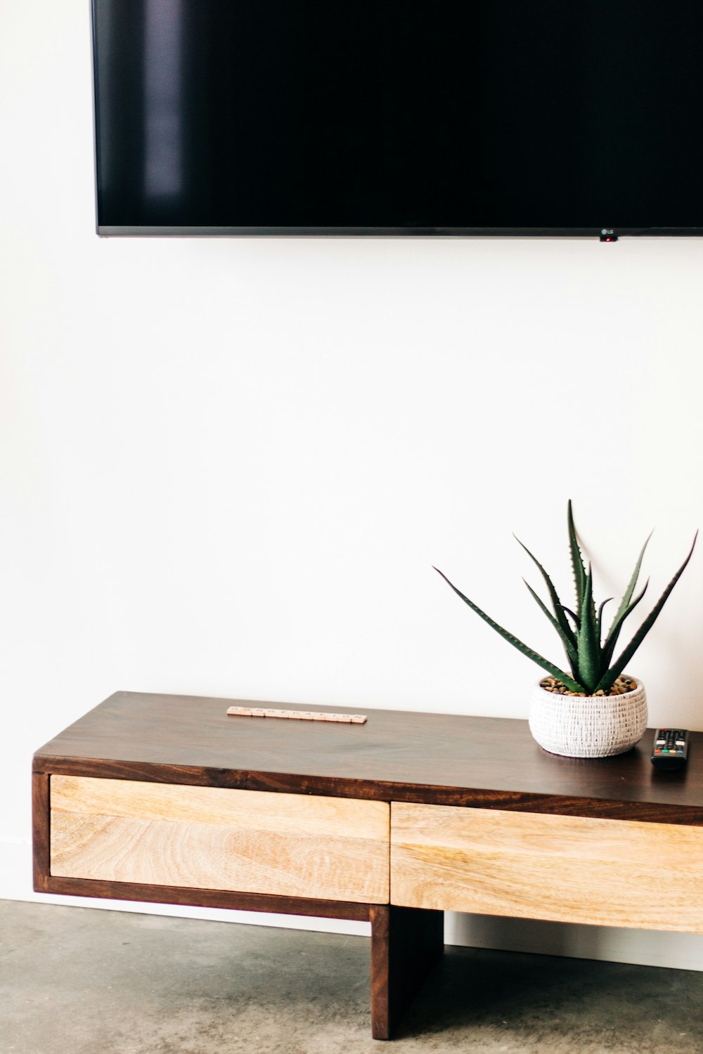 a wooden table with a plant on top of it