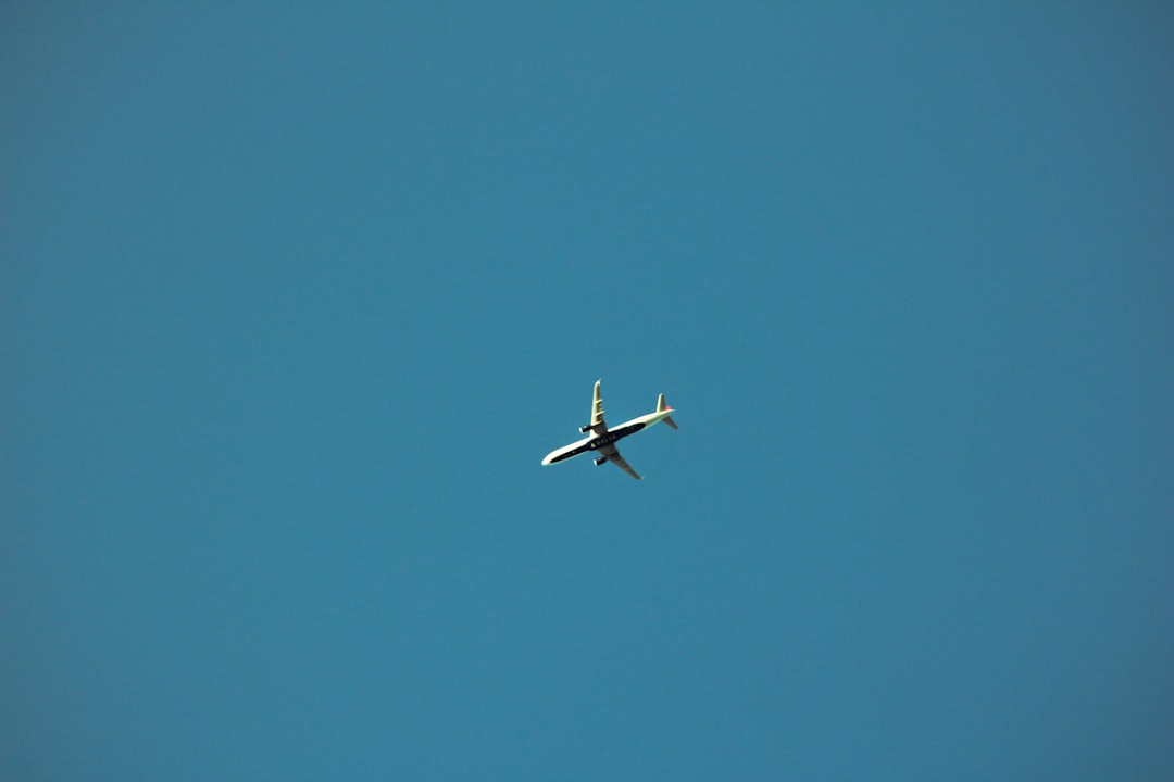 an airplane is flying in a clear blue sky,