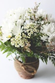 Elegant cream-white lilies arranged delicately in a rustic basket.