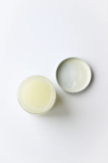 two small white bowls sitting next to each other