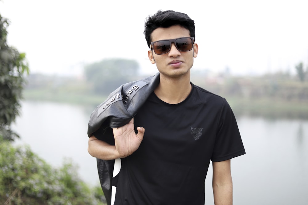 a man wearing a black shirt and sunglasses