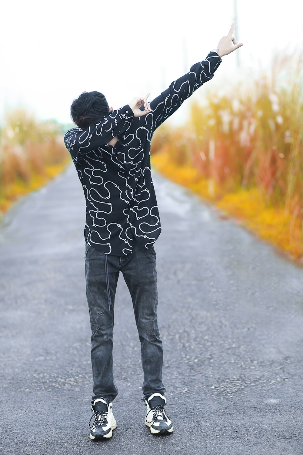 a man standing in the middle of a road