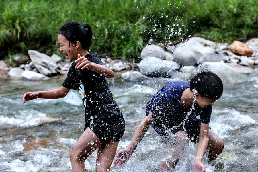 Children playing and splashing in a clear river