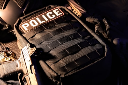 a close up of a police vest with a gun
